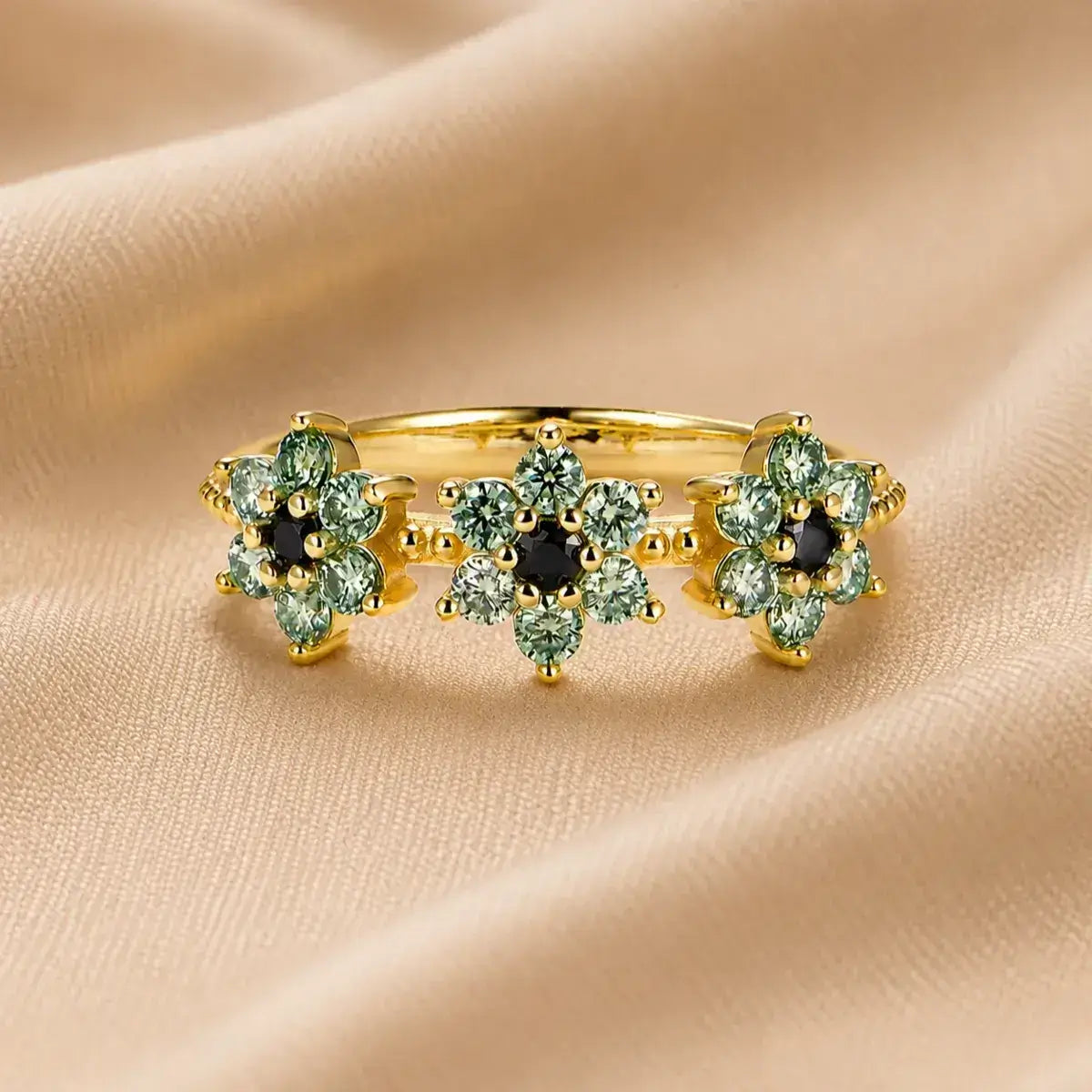 Anel em prata 925 banhado a ouro com três flores de moissanite ciano e preto