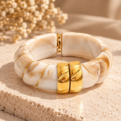Pulseira de resina bege larga com design geométrico e acabamento dourado