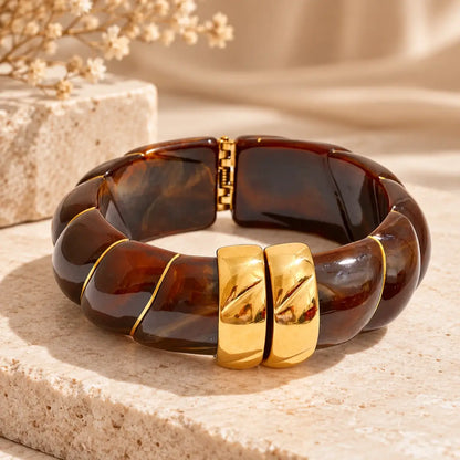 Pulseira de resina castanha larga com design geométrico e acabamento dourado